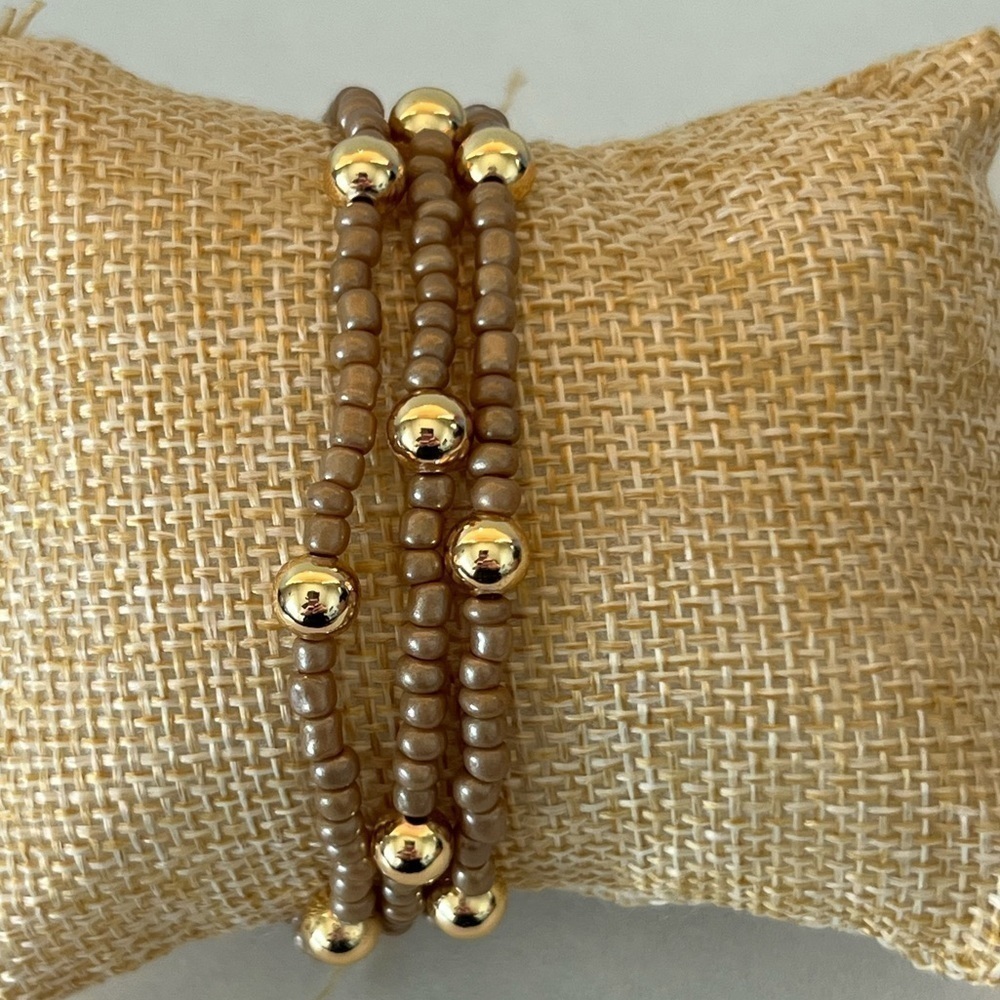 Brown/tan beaded bracelets with gold plated beads size 7”